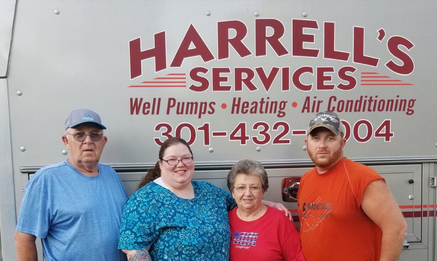 The Harrell family in front of a Harrell's Services van